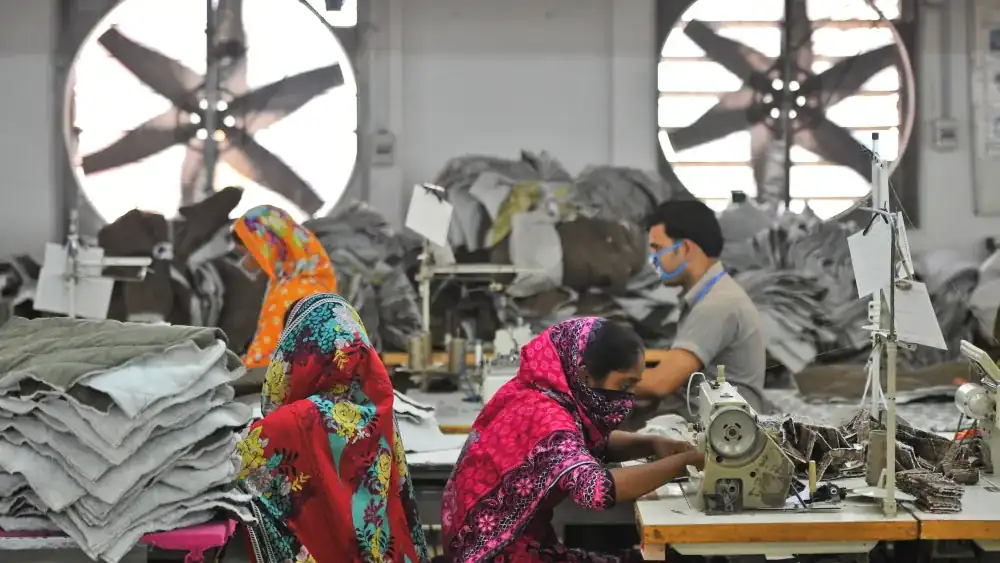 Operators sewing at a ventilated sewing line, garment factory in Dhaka, Bangladesh, DRESSOURCE