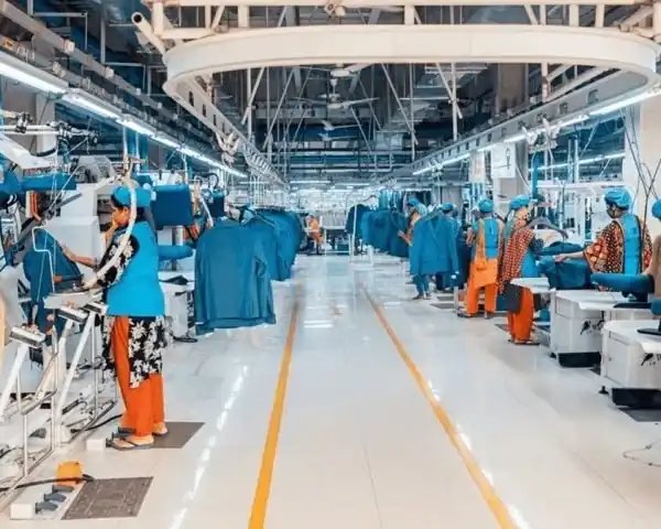 Bright garment production floor with sewing lines and operators in teal uniforms, Dhaka, Bangladesh, DRESSOURCE