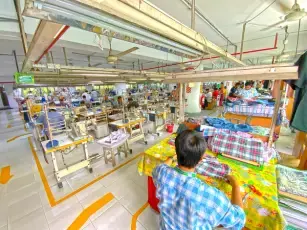 Overhead view of an apparel production floor with sewing stations, garment factory Dhaka, Bangladesh, DRESSOURCE